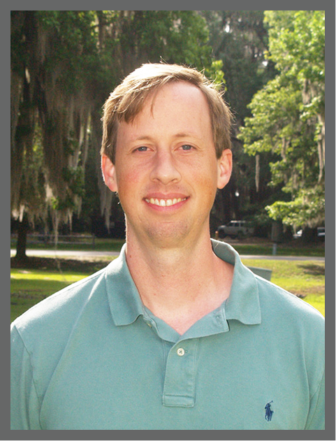 Dr. Adam Greer outdoors at the University of Georgia Skidaway Institute of Oceanography.